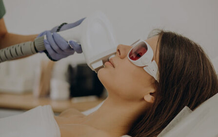 Woman receiving a facial treatment from a professional in a medspa setting
